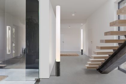 White villa interior wih staircase and decorative houseplant